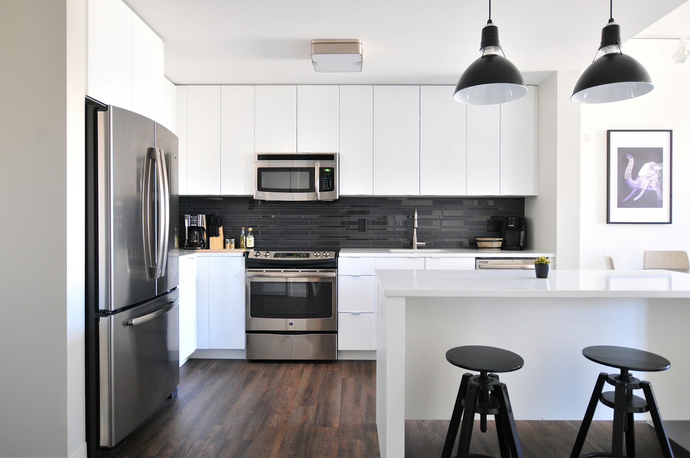A modern home kitchen with refrigerator, range, and microwave
